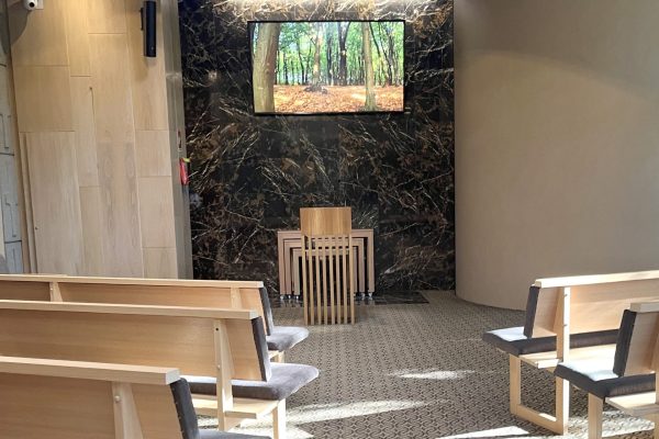 Wilson Chapel Interior in Melbourne with Wooden Seating and Floral Display